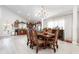 Elegant dining room with a wooden table and chairs open to kitchen with modern appliances at 3244 Amaca Cir, Orlando, FL 32837