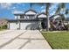 Inviting two-story home with a well-manicured lawn and a three-car garage at 3244 Amaca Cir, Orlando, FL 32837