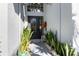 Inviting front entrance featuring a decorative door, lush plants, and charming garden accents at 3244 Amaca Cir, Orlando, FL 32837