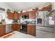 An eat-in kitchen boasts modern appliances, granite countertops, and wood cabinets at 3244 Amaca Cir, Orlando, FL 32837