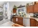 Well-lit kitchen showcasing granite countertops, stainless steel dishwasher, and a view to the outdoors at 3244 Amaca Cir, Orlando, FL 32837