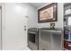 Laundry room featuring modern washer and dryer next to a door at 3244 Amaca Cir, Orlando, FL 32837
