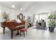 Elegant living room with a grand piano, stylish decor, and bright natural light at 3244 Amaca Cir, Orlando, FL 32837