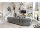Open-concept living room with a fireplace, custom built-ins, and decoratively adorned shelving at 3244 Amaca Cir, Orlando, FL 32837