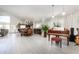 Open floor plan featuring a piano, dining area, and a spacious living space with light wood floors at 3244 Amaca Cir, Orlando, FL 32837