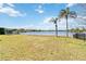 Beautiful backyard featuring a lush lawn leading to a serene lake, perfect for relaxation and recreation at 330 Osprey Lakes Cir, Chuluota, FL 32766