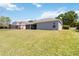 Large, fenced backyard featuring lush green grass and mature trees, perfect for outdoor activities and relaxation at 330 Osprey Lakes Cir, Chuluota, FL 32766