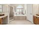 Bright bathroom features a soaking tub, separate shower, and vanity with ample counter space at 330 Osprey Lakes Cir, Chuluota, FL 32766