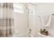 Cozy bathroom features a shower with a rainfall shower head, window, and modern fixtures at 330 Osprey Lakes Cir, Chuluota, FL 32766