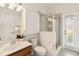 Well-lit bathroom with a glass-enclosed shower, toilet, and vanity with modern fixtures at 330 Osprey Lakes Cir, Chuluota, FL 32766
