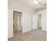 Spacious bedroom with plush carpeting, ceiling fan, and doors to the ensuite bath and closet at 330 Osprey Lakes Cir, Chuluota, FL 32766