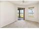 Bright bedroom with sliding glass doors to the patio and a view of the lake at 330 Osprey Lakes Cir, Chuluota, FL 32766