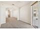 Open bedroom with carpeting and arched entryway, leading to additional living spaces at 330 Osprey Lakes Cir, Chuluota, FL 32766