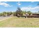 Community entrance with mature landscaping, decorative brick pillars, and ornamental sign at 330 Osprey Lakes Cir, Chuluota, FL 32766