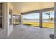 Spacious covered patio with views of the lush yard and tranquil lake at 330 Osprey Lakes Cir, Chuluota, FL 32766