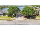 Charming home exterior with a well-manicured lawn, mature trees, and a welcoming driveway at 330 Osprey Lakes Cir, Chuluota, FL 32766