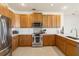 Well-lit kitchen with stainless steel appliances and tile flooring at 330 Osprey Lakes Cir, Chuluota, FL 32766