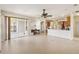 Open living space connected to the kitchen, filled with natural light and tile flooring at 330 Osprey Lakes Cir, Chuluota, FL 32766