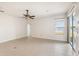 Spacious living area with tile flooring, ceiling fan, and sliding glass doors with lake views at 330 Osprey Lakes Cir, Chuluota, FL 32766