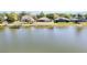 Rear exterior of home facing a pond with an alligator at 330 Osprey Lakes Cir, Chuluota, FL 32766