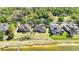 Home exterior with large backyard, waterfront access, and a partially covered patio at 330 Osprey Lakes Cir, Chuluota, FL 32766