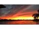 Scenic view of the lake during a colorful sunset with pink and yellow skies at 330 Osprey Lakes Cir, Chuluota, FL 32766