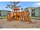 Outdoor playground area featuring a wooden play structure, slide, and soft ground covering at 336 Scottsdale Sq # 336, Winter Park, FL 32792