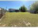 Expansive backyard featuring a screened porch, storage shed, and plenty of space for outdoor activities at 38 Juniper Pass Dr, Ocala, FL 34480