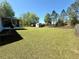 Large backyard with a shed and a fence on a sunny day at 38 Juniper Pass Dr, Ocala, FL 34480