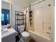 Functional bathroom featuring a shower-tub combo, vanity, and shelving at 38 Juniper Pass Dr, Ocala, FL 34480