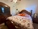 Spacious bedroom with a decorative wooden bed frame and a neutral color scheme at 38 Juniper Pass Dr, Ocala, FL 34480