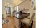 Bright kitchen with wood-look flooring, granite countertops, and convenient breakfast bar seating at 38 Juniper Pass Dr, Ocala, FL 34480