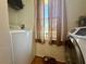 Well-lit laundry room with modern appliances and a window offering natural light at 38 Juniper Pass Dr, Ocala, FL 34480