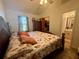Spacious main bedroom featuring a ceiling fan, a patterned comforter and an attached bath at 38 Juniper Pass Dr, Ocala, FL 34480