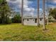 A view of a large private backyard surrounded by trees at 41214 Posey Dr, Eustis, FL 32736