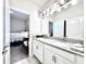 Bright bathroom featuring double sinks, white cabinetry, and modern lighting at 4562 Tribute Trl, Kissimmee, FL 34746