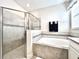 Modern bathroom featuring a glass-enclosed shower, soaking tub, and tasteful tile work for a spa-like experience at 4562 Tribute Trl, Kissimmee, FL 34746