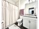 Bright bathroom with a shower featuring a decorative curtain and a white single sink vanity at 4562 Tribute Trl, Kissimmee, FL 34746