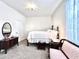 Comfortable bedroom with soft carpet, a classic bed frame, and a decorative chair at 4562 Tribute Trl, Kissimmee, FL 34746