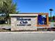 Stone sign reads: Hideaway Club at Story Lake, with modern metal art behind at 4562 Tribute Trl, Kissimmee, FL 34746