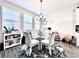 Cozy breakfast nook features round glass table, stylish chairs, and light-filled windows at 4562 Tribute Trl, Kissimmee, FL 34746