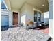 Inviting covered front porch with stylish seating, a decorative bicycle planter, and a welcoming entrance at 4562 Tribute Trl, Kissimmee, FL 34746