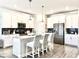 Modern kitchen with stainless steel appliances, a large island, and white cabinets at 4562 Tribute Trl, Kissimmee, FL 34746