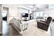 Bright living room with a ceiling fan, television, and comfortable striped couches at 4562 Tribute Trl, Kissimmee, FL 34746