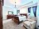 Cozy main bedroom with a large bed, elegant furniture, carpet and curtains for a comfortable retreat at 4562 Tribute Trl, Kissimmee, FL 34746