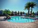 Inviting community swimming pool surrounded by lush palm trees and brick decking at 4562 Tribute Trl, Kissimmee, FL 34746