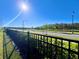 Street view with picturesque pond and tree lined sidewalks at 4562 Tribute Trl, Kissimmee, FL 34746