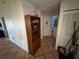 Hallway with tile flooring, decorated walls, and doors leading to other rooms at 46 Silver Park Cir, Kissimmee, FL 34743
