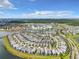 Expansive aerial view of a Primary-planned community with homes, lakes, and resort-style amenities on a sunny day at 4704 Sleepy Hollow Dr, Kissimmee, FL 34746