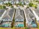 Aerial view showing a block of houses with screened in pools in their backyards at 4704 Sleepy Hollow Dr, Kissimmee, FL 34746